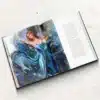 Open hardcover oil painting-style art book