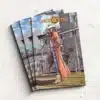 Pile of closed custom softcover comics with colorful artwork